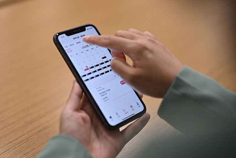 Hand holding Otis Customer App