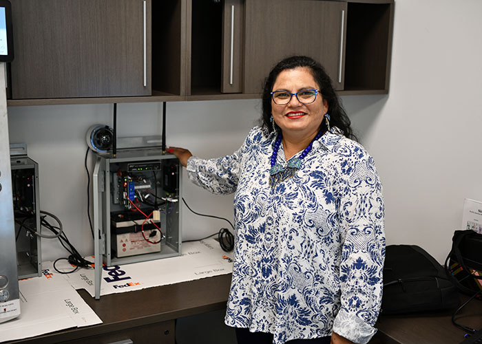 Otis employee in front of a desk