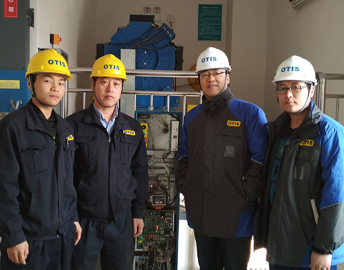 Picture of four Otis employees at a field location